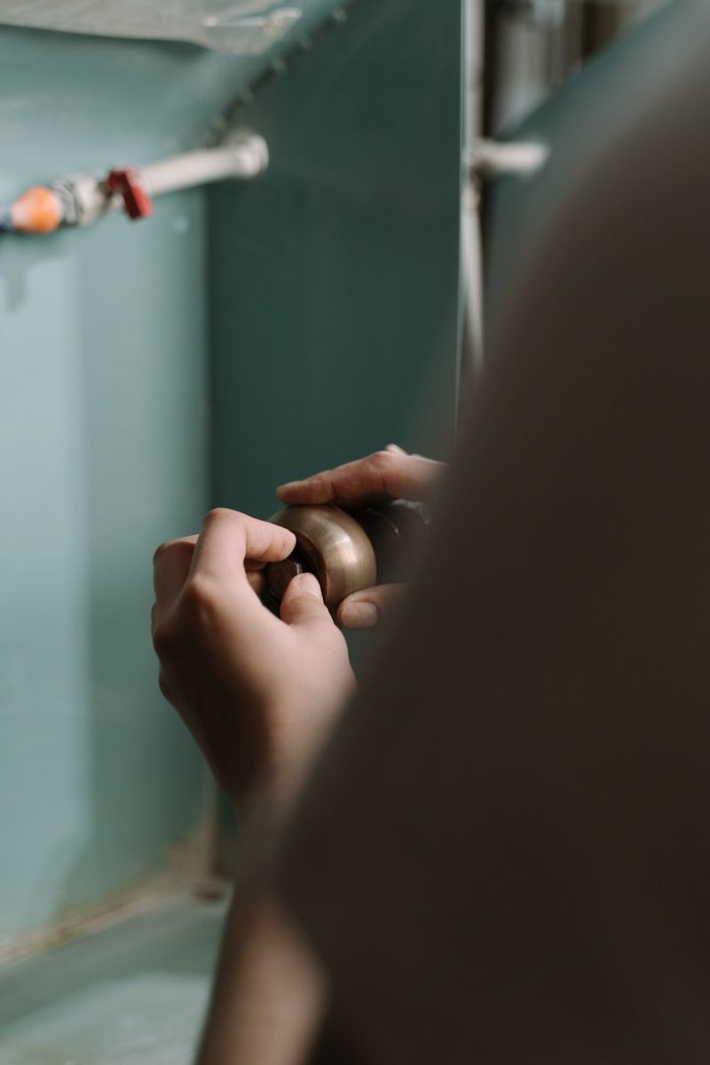 Plomero reparando tuberías bajo el fregadero